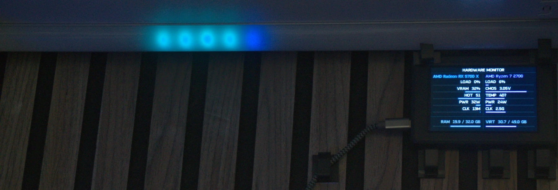 Desktop Shrine hardware telemetry rendered on a GOverlay display beside ambient lighting